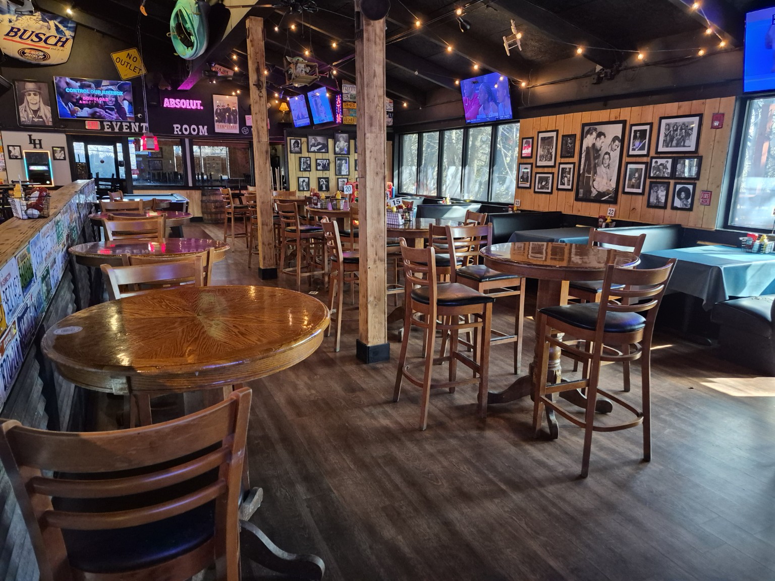 Canton Icehouse dining room with wood tables, booths and framed music memorabilia.
