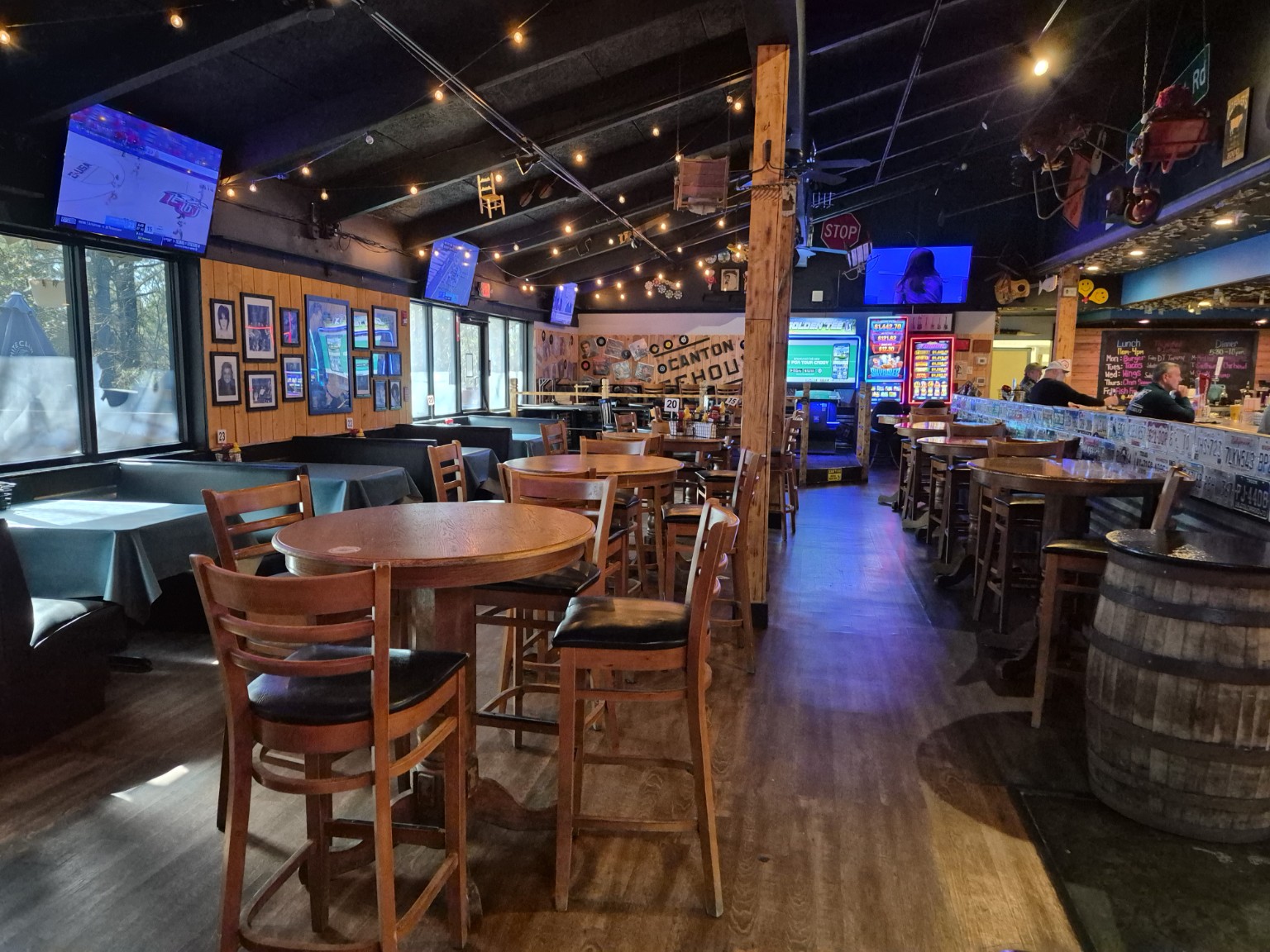 View down the Canton Icehouse dining room toward the bar, televisions and game area.